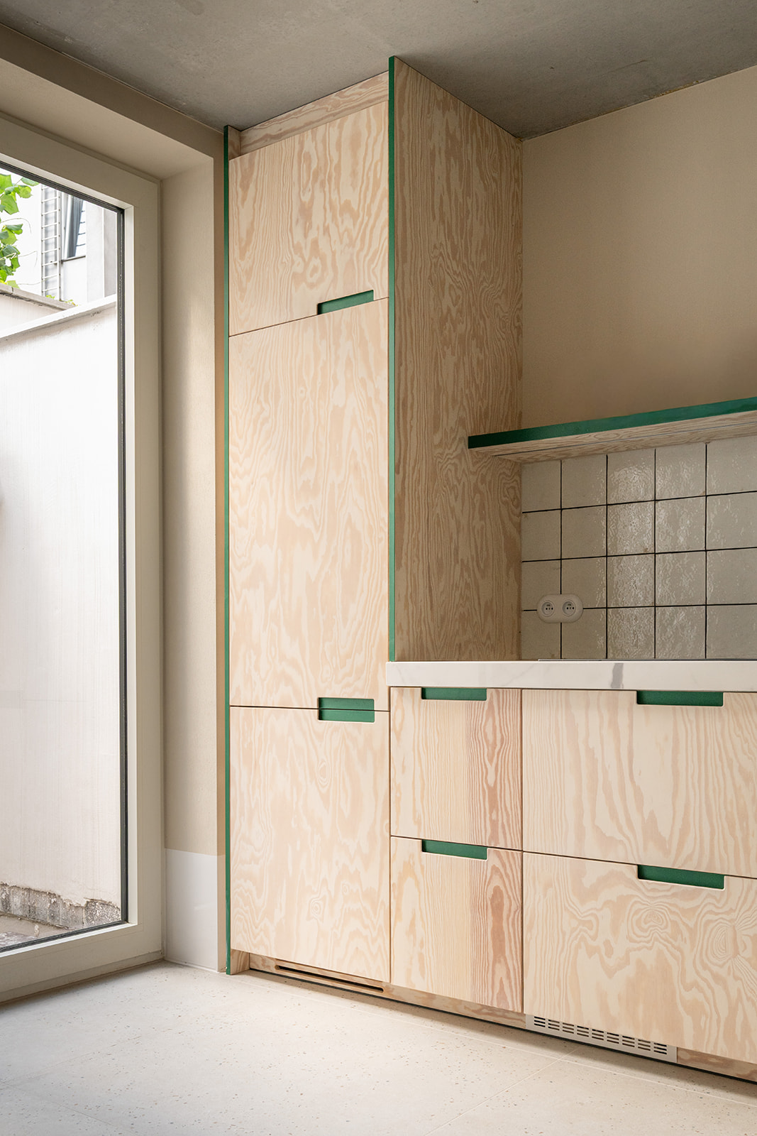 Plywood kitchen with green handles