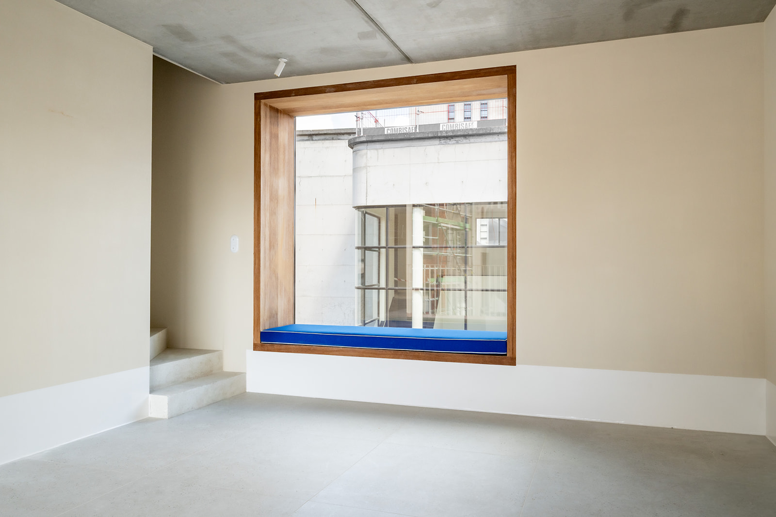 Blue bench in wood-framed window nook